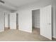 Spacious bedroom with neutral carpet, multiple doors, and a walk-in closet at 7440 S Blackhawk St # 207, Englewood, CO 80112