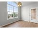 Bright dining area with large windows offering lovely views and tiled floors, complemented by a stylish light fixture at 7440 S Blackhawk St # 207, Englewood, CO 80112