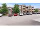 Exterior building shot showing the architectural details of this multi-story apartment complex with ample parking space at 7440 S Blackhawk St # 207, Englewood, CO 80112