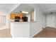 Kitchen area featuring wooden cabinets, a breakfast bar, black appliances and seamless flow to the dining area at 7440 S Blackhawk St # 207, Englewood, CO 80112