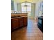 Bright kitchen area featuring tile flooring, wooden cabinets, and a sink under a high, arched window at 7440 S Blackhawk St # 207, Englewood, CO 80112