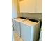 Laundry room featuring a washer, dryer, and upper cabinets, providing functional storage at 7440 S Blackhawk St # 207, Englewood, CO 80112