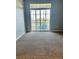 Living room featuring neutral carpet, sliding glass doors to private deck for relaxing outdoor living at 7440 S Blackhawk St # 207, Englewood, CO 80112