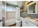 Cozy bathroom featuring a shower-tub combo, neutral tile, updated sink, and stylish vanity mirror at 3530 W 95Th Ave, Westminster, CO 80031