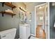 Updated bathroom with neutral paint, vanity, shelving, and a doorway leading to the hallway at 3530 W 95Th Ave, Westminster, CO 80031