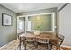 Cozy dining room featuring a wooden table, woven chairs, and a picture window at 3530 W 95Th Ave, Westminster, CO 80031