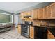 Spacious kitchen featuring wood cabinets, black appliances, and a dining nook at 3530 W 95Th Ave, Westminster, CO 80031