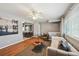 Bright living room with hardwood floors, modern furniture, and a view into the dining area at 3530 W 95Th Ave, Westminster, CO 80031