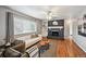 Inviting living room with a brick fireplace, built-in shelves, and hardwood floors at 3530 W 95Th Ave, Westminster, CO 80031