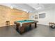 Game room featuring a pool table and wood wall at 7877 E Mississippi Ave # 604, Denver, CO 80247