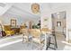 Sunlit dining room with wooden table and chairs, kitchen view at 7877 E Mississippi Ave # 604, Denver, CO 80247