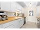 Modern kitchen with butcher block counters, stainless steel appliances, and white cabinetry at 7877 E Mississippi Ave # 604, Denver, CO 80247