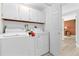 White washer and dryer in well-lit laundry room at 7877 E Mississippi Ave # 604, Denver, CO 80247