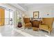 Two yellow armchairs and a guitar in a sunlit living area at 7877 E Mississippi Ave # 604, Denver, CO 80247