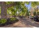 Community patio with ample seating, grill, and large shade tree at 7877 E Mississippi Ave # 604, Denver, CO 80247