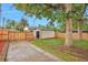 A well-maintained backyard with a new wooden fence and a detached garage at 1325 Dayton St, Aurora, CO 80010