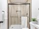 Modern bathroom with walk-in shower, sleek fixtures, and wood-look tiling at 1325 Dayton St, Aurora, CO 80010
