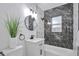 Contemporary bathroom showcasing black marble accent wall, tub, and modern vanity at 1325 Dayton St, Aurora, CO 80010