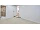 Cozy bedroom with neutral carpet, white walls and trim, and doorway to bathroom at 1325 Dayton St, Aurora, CO 80010
