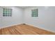 Bright bedroom with hardwood floors, white trim and walls, and large windows at 1325 Dayton St, Aurora, CO 80010