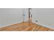 Empty room featuring refinished hardwood floors, white baseboards and trim at 1325 Dayton St, Aurora, CO 80010