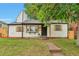 Charming home featuring a well-manicured lawn, quaint shutters, and a welcoming front entrance at 1325 Dayton St, Aurora, CO 80010