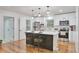 Modern kitchen with stainless steel appliances, a central island with seating, and white cabinets at 1325 Dayton St, Aurora, CO 80010
