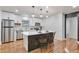 Modern kitchen with stainless steel appliances, a central island with seating, and pendant lighting at 1325 Dayton St, Aurora, CO 80010