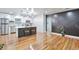 Spacious living room with hardwood floors adjacent to a modern, stylish kitchen at 1325 Dayton St, Aurora, CO 80010