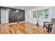 Modern living room with dark accent wall, hardwood floors, and ample natural light at 1325 Dayton St, Aurora, CO 80010