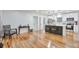 Open-concept living room featuring hardwood floors, an open kitchen, and natural light at 1325 Dayton St, Aurora, CO 80010