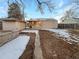 Spacious backyard with a detached shed and a covered patio; some snow is visible on the ground at 1920 Alton St, Aurora, CO 80010