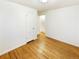 Bedroom with hardwood floors, white trim, and closet with white door at 1920 Alton St, Aurora, CO 80010