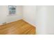 Bedroom featuring hardwood flooring, white trim, one window, and neutral walls at 1920 Alton St, Aurora, CO 80010