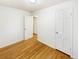 Bedroom featuring hardwood flooring, white trim, closet with white door and neutral walls at 1920 Alton St, Aurora, CO 80010