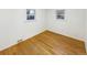 Empty bedroom featuring hardwood floors, two windows, and white walls at 1920 Alton St, Aurora, CO 80010