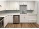 Modern kitchen with stainless steel appliances, white cabinets, light countertops and subway tile backsplash at 1920 Alton St, Aurora, CO 80010