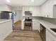 Modern kitchen featuring stainless steel appliances, white cabinetry, and stylish countertops at 1920 Alton St, Aurora, CO 80010