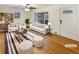 Bright, virtually staged living room with hardwood floors, stylish furniture, and a large sliding glass door at 1920 Alton St, Aurora, CO 80010