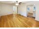 Bright living room featuring hardwood floors, built-in shelves, and an open floor plan at 1920 Alton St, Aurora, CO 80010