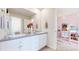 Double vanity bathroom with gray counters and white cabinets at 3158 S Nepal Way, Aurora, CO 80013