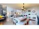 Open dining area with farmhouse table and view into living room at 3158 S Nepal Way, Aurora, CO 80013