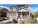 Charming two-story home with stone accents, solar panels, and a cozy front porch at 3158 S Nepal Way, Aurora, CO 80013