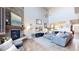 Bright living room featuring a stone fireplace and hardwood floors at 3158 S Nepal Way, Aurora, CO 80013