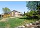 Large backyard with green grass, landscaping, and a patio, ideal for entertaining and outdoor living at 4860 E 120Th Pl, Thornton, CO 80241