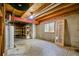 Spacious unfinished basement with shelving, a window, and room for storage or hobbies at 4860 E 120Th Pl, Thornton, CO 80241