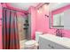 Pink full bathroom with shower and tub combo and updated vanity sink at 4860 E 120Th Pl, Thornton, CO 80241