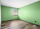 Bedroom showcasing wood-look floors, a window with blinds and vibrant painted walls at 4860 E 120Th Pl, Thornton, CO 80241