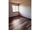 Bedroom featuring hardwood floors and a window with natural light at 4860 E 120Th Pl, Thornton, CO 80241