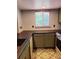 Cozy kitchen with custom cabinets, and a patterned tile floor at 4860 E 120Th Pl, Thornton, CO 80241